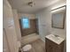 Bathroom features a tub and shower combo, new sink, and gray tile accents at 3629 Birchwood Ave, Indianapolis, IN 46205