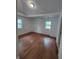 Bedroom with two windows and hardwood floors at 3629 Birchwood Ave, Indianapolis, IN 46205