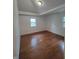 Bright bedroom with hardwood floors, tray ceiling, and natural light from the windows at 3629 Birchwood Ave, Indianapolis, IN 46205