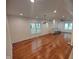 Spacious living room with recessed lighting, hardwood floors, and large windows at 3629 Birchwood Ave, Indianapolis, IN 46205