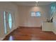 Inviting living area featuring hardwood floors, fresh paint, and natural light from a front door at 3629 Birchwood Ave, Indianapolis, IN 46205