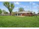 Expansive backyard features a well-maintained lawn, brick home exterior, and covered deck at 4044 Roamin Dr, Greenwood, IN 46142