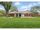 Spacious backyard showcases a brick home with a large deck, ideal for outdoor entertainment at 4044 Roamin Dr, Greenwood, IN 46142