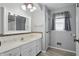 Bright bathroom features a marble countertop vanity, decorative mirror, and mosaic tile accents at 4044 Roamin Dr, Greenwood, IN 46142