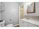 Bathroom vanity with mosaic backsplash and updated lighting at 4044 Roamin Dr, Greenwood, IN 46142
