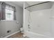 Clean bathroom features a white tiled shower-tub combo and a window providing natural light at 4044 Roamin Dr, Greenwood, IN 46142