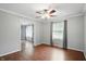 Cozy bedroom features laminate wood floors, neutral walls, a ceiling fan, and a sunlit window at 4044 Roamin Dr, Greenwood, IN 46142