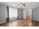 Comfortable bedroom featuring hardwood floors, neutral walls, a ceiling fan, and a large window at 4044 Roamin Dr, Greenwood, IN 46142