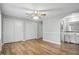 A bright bedroom with hardwood floors, a ceiling fan, and three closets for ample storage at 4044 Roamin Dr, Greenwood, IN 46142