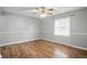 Comfortable bedroom with neutral walls, new flooring and a bright window at 4044 Roamin Dr, Greenwood, IN 46142
