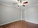 Neutral bedroom with wood floors, ceiling fan, and doorway to another room at 4044 Roamin Dr, Greenwood, IN 46142