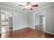 Open-concept dining room featuring wood floors, neutral walls, and access to kitchen and other rooms at 4044 Roamin Dr, Greenwood, IN 46142