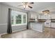 Open kitchen and dining area with large bay window, white cabinets and wood-look floors at 4044 Roamin Dr, Greenwood, IN 46142