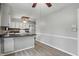 Spacious kitchen with eat-in bar, white cabinets and appliances, and wood-look floors at 4044 Roamin Dr, Greenwood, IN 46142