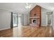 Cozy living room with brick fireplace, hardwood floors, and natural light at 4044 Roamin Dr, Greenwood, IN 46142