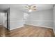 A spacious living room featuring hardwood floors, a ceiling fan, and neutral wall colors at 4044 Roamin Dr, Greenwood, IN 46142