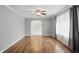Sun-filled living room featuring hardwood floors, neutral walls, and an arched entryway to another room at 4044 Roamin Dr, Greenwood, IN 46142