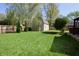 Large backyard with a wooden storage shed, mature trees, and lush green grass at 4257 Locust Ln, Brownsburg, IN 46112