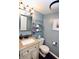 Cozy bathroom featuring a sink vanity, toilet, and tasteful wall decor at 4257 Locust Ln, Brownsburg, IN 46112