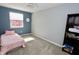 Bedroom with a pink comforter on bed with a window and bookcase at 4257 Locust Ln, Brownsburg, IN 46112