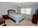 This bedroom has a ceiling fan, a bed with a padded headboard, and neutral carpet at 4257 Locust Ln, Brownsburg, IN 46112