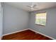 Empty bedroom with hardwood floors, light grey walls and a window at 4257 Locust Ln, Brownsburg, IN 46112