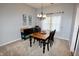 Cozy dining room featuring a chandelier, wooden table, and a window for natural light at 4257 Locust Ln, Brownsburg, IN 46112