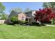 Charming two-story home with brick accents, mature landscaping, and a well-manicured lawn at 4257 Locust Ln, Brownsburg, IN 46112