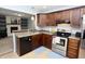 Functional kitchen with stainless steel appliances and dark wood cabinets, perfect for cooking at 4257 Locust Ln, Brownsburg, IN 46112