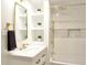 Bathroom with white vanity, gold fixtures, and a shower featuring subway tiles and a rain-style showerhead at 474 N Randolph St, Indianapolis, IN 46201