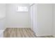 Bedroom featuring a small window and a bi-fold door closet, complemented by hard surface flooring at 474 N Randolph St, Indianapolis, IN 46201
