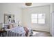 Bright bedroom features a stylish bed, modern light fixture, and a large window at 474 N Randolph St, Indianapolis, IN 46201