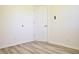 Bedroom with hard surface flooring, white walls and trim, plus a door with gold hardware at 474 N Randolph St, Indianapolis, IN 46201