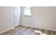 Minimalist bedroom with wood-look floors, white walls, and natural light at 474 N Randolph St, Indianapolis, IN 46201