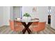 Cozy dining area features a round glass-top table with wood base and four orange chairs at 474 N Randolph St, Indianapolis, IN 46201
