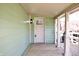 Covered porch features wooden floors, painted railings, and a paneled front door with sidelight at 474 N Randolph St, Indianapolis, IN 46201