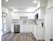 Modern kitchen featuring white cabinets, stainless steel appliances, and updated backsplash at 474 N Randolph St, Indianapolis, IN 46201