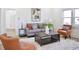 Bright living area featuring a gray couch, orange armchairs, and a large, patterned area rug at 474 N Randolph St, Indianapolis, IN 46201