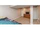 Modest basement bedroom featuring carpet, a dresser with a TV, and closet access at 480 E Walnut St, Martinsville, IN 46151