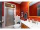 Bathroom with red walls, features a white sink and toilet, plus a standing glass shower at 480 E Walnut St, Martinsville, IN 46151