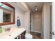 Updated bathroom featuring a modern sink, toilet, vanity, and shower with tiled walls at 480 E Walnut St, Martinsville, IN 46151