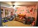 A pink Bedroom with a fan, crib, and a flower design on the walls at 480 E Walnut St, Martinsville, IN 46151