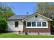 Charming home with tan siding, brick foundation, and a well-maintained lawn at 480 E Walnut St, Martinsville, IN 46151