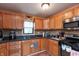 Functional kitchen space featuring tile backsplash, ample counter space, and wood cabinets at 480 E Walnut St, Martinsville, IN 46151