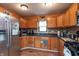 Well-appointed kitchen with stainless steel appliances and warm wood cabinetry at 480 E Walnut St, Martinsville, IN 46151