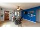Cozy living room featuring neutral carpet, a ceiling fan, and accent wall at 480 E Walnut St, Martinsville, IN 46151