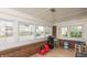 Bright sunroom with multiple windows, brick accents and light tile floors at 480 E Walnut St, Martinsville, IN 46151