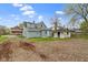 View of the home's backyard, detached garage, and blue clapboard siding at 524 S State St, Greenfield, IN 46140