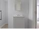 Bathroom featuring a white sink and vanity with square mirror and tile flooring at 524 S State St, Greenfield, IN 46140