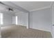 Spacious bedroom with neutral carpet, a ceiling fan and a large window at 524 S State St, Greenfield, IN 46140